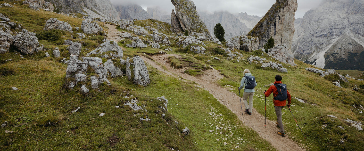 Two hikers on a path in the Dolomites