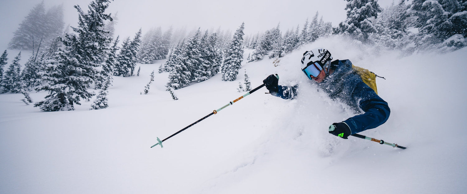 A skier charges through waist deep powder