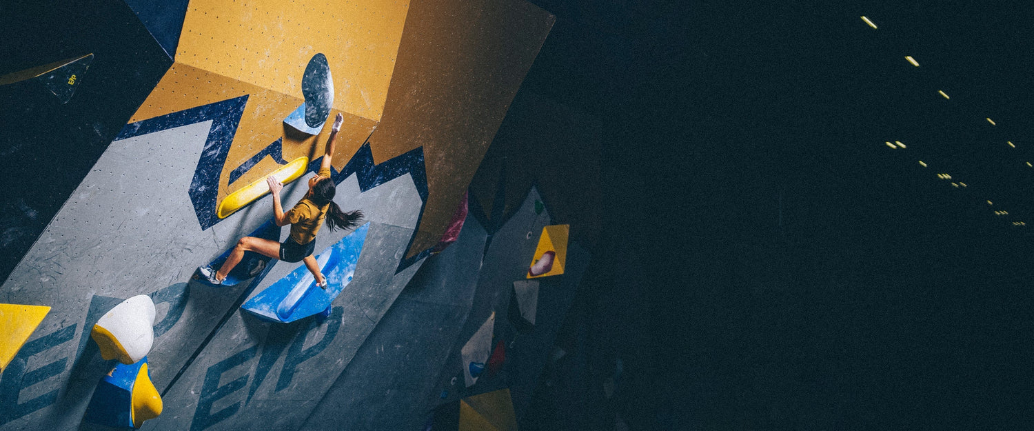 BD athlete Natalia Grossman reaches for a hold while bouldering