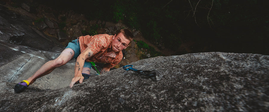 A climber looks up at a quickdraw in Mazama, Washington