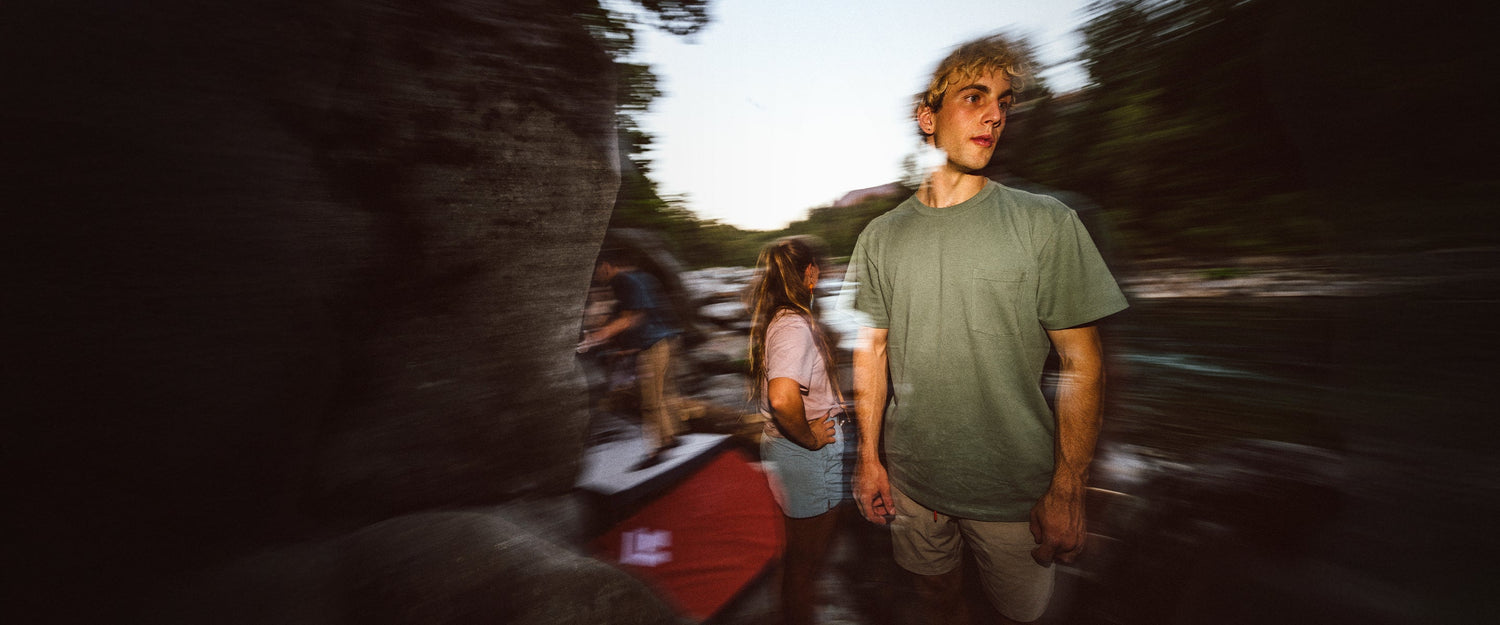 A climber stands near a boulder in Mazama, WA