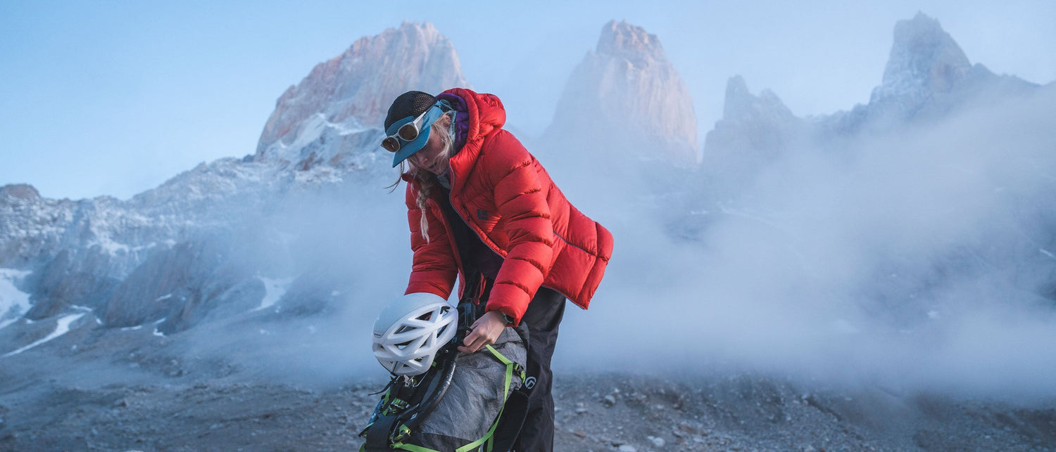 A mountaineering adjusts her pack in Patagonia