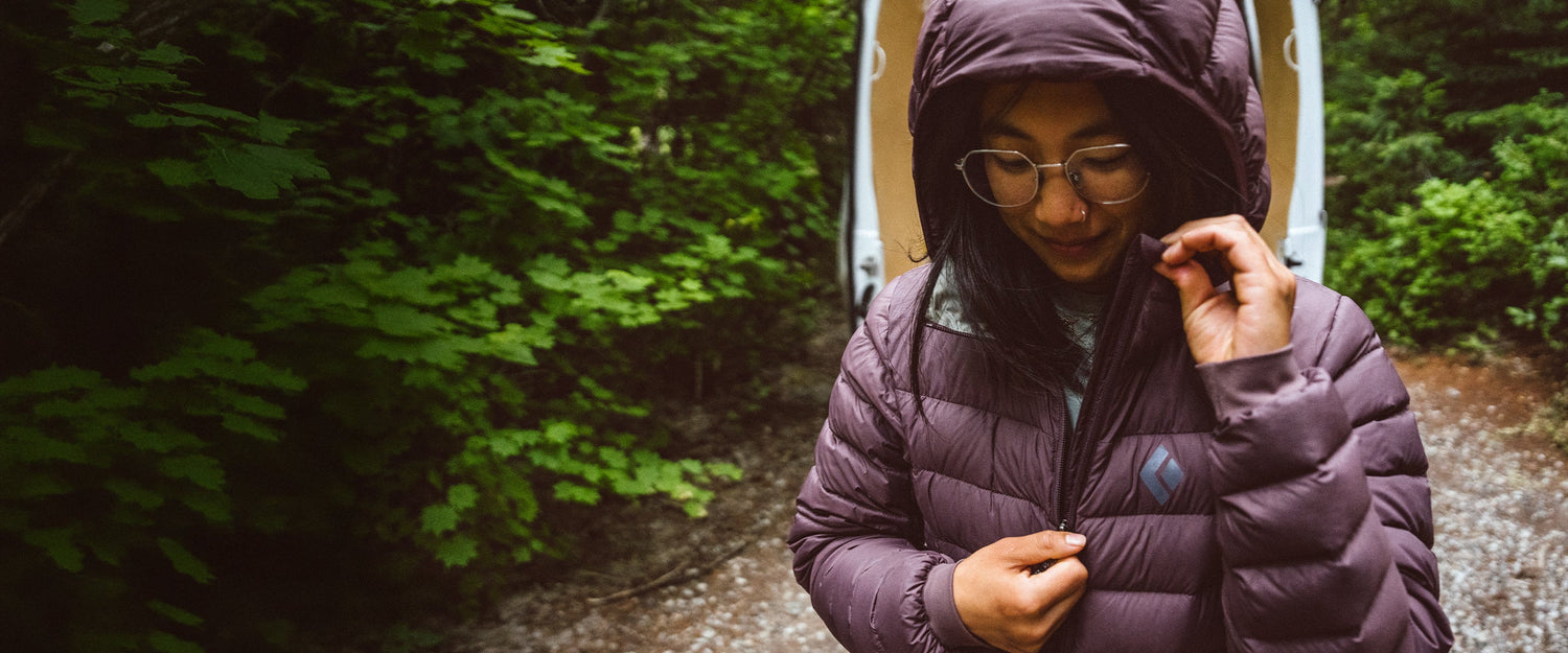 A women zips up her access down hoody