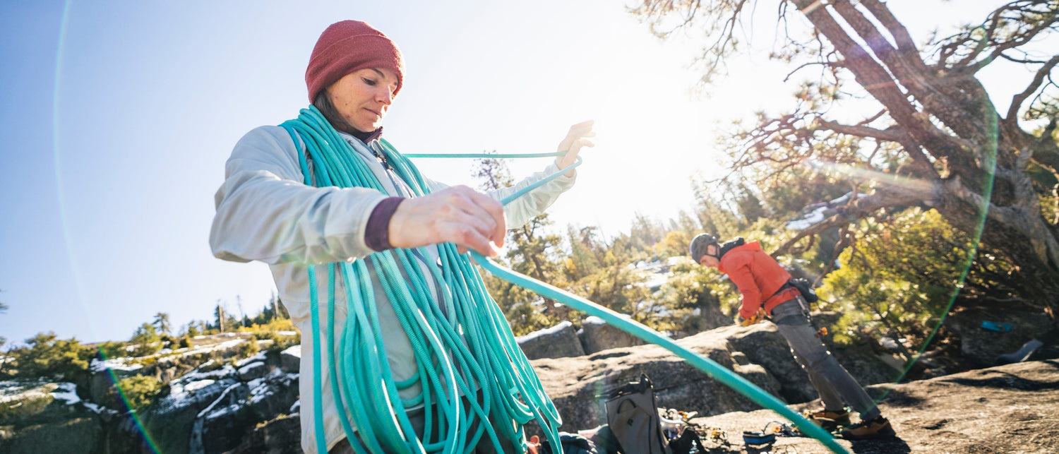 Babsi coiling a rope at the tope of a climb in Yosemite.