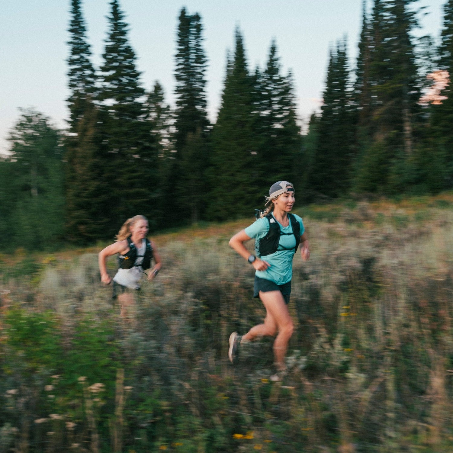 BD athlete Kelly Halpin and friend run through a field in Wyoming.