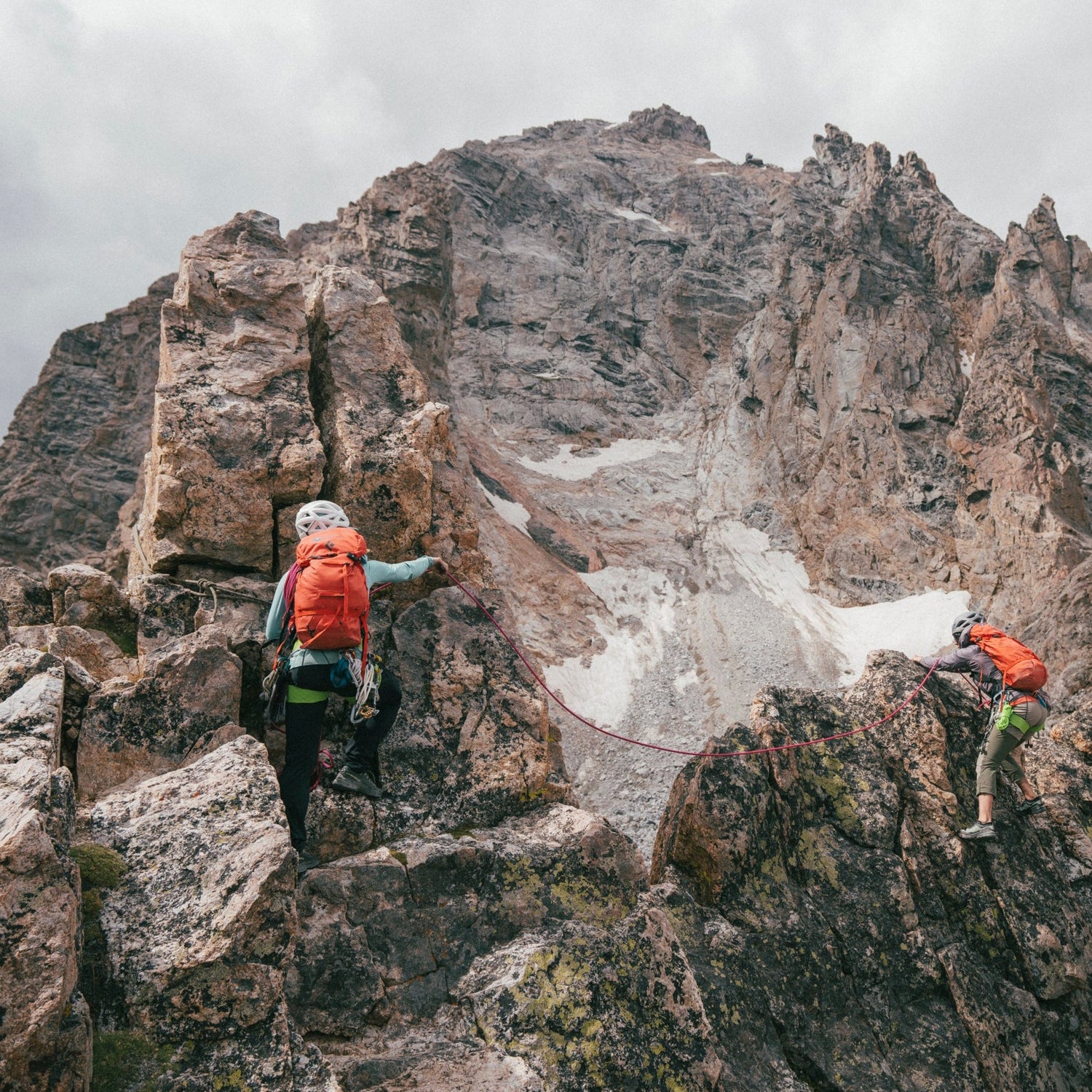Two climbers in the Tetons on a cloudy day.