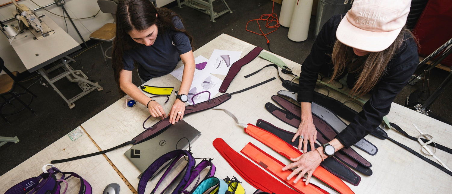 Two BD employees inspect parts of the zone harness.