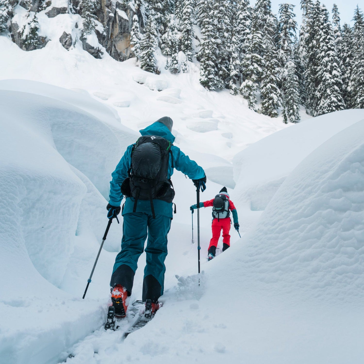 Two skiers tour through pillows in the Cascades
