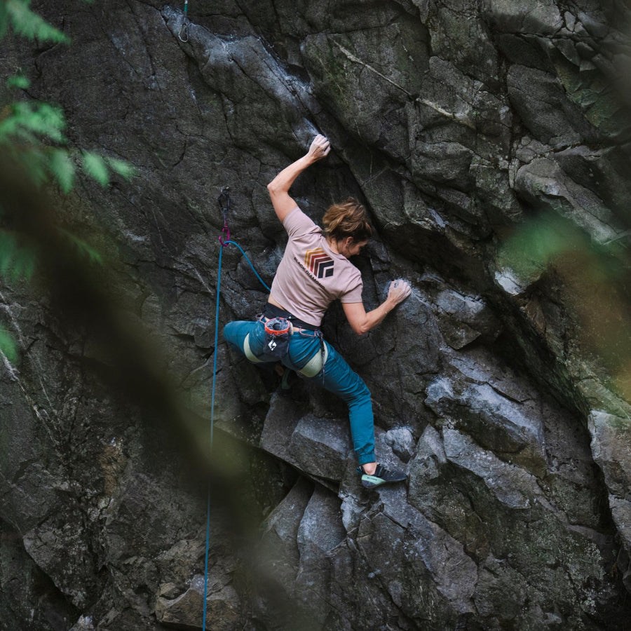 A climber on a granite wall wears a BD tee.