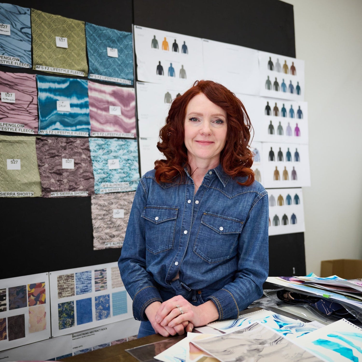 Heidi Lister Hevsy in front of fabric swatches.