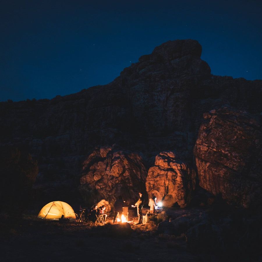 Campers at night illuminated by Black Diamond lanterns.