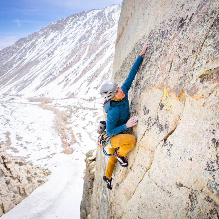 A climber reaches on the wall in windy Pine Creek.